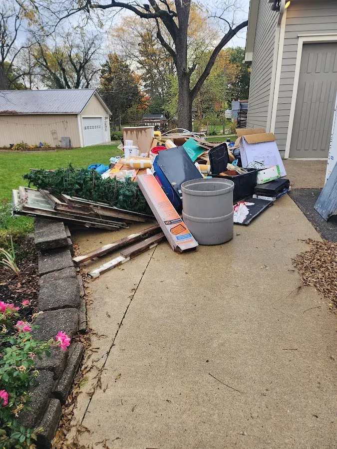 Dumpster being loaded with debris for 10 Yard Dumpster Rental in Tolland